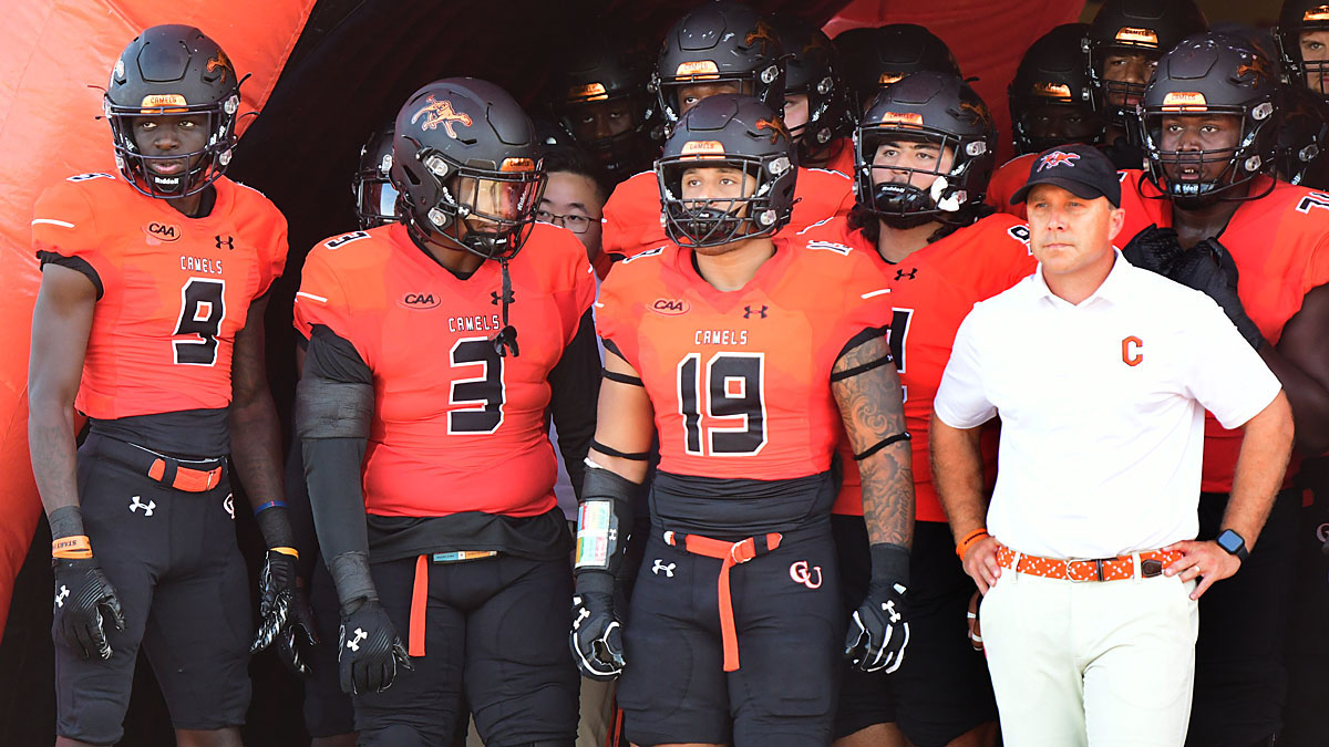 Campbell football players and coach Braxton Harris before a 2024 game against Stony Brook