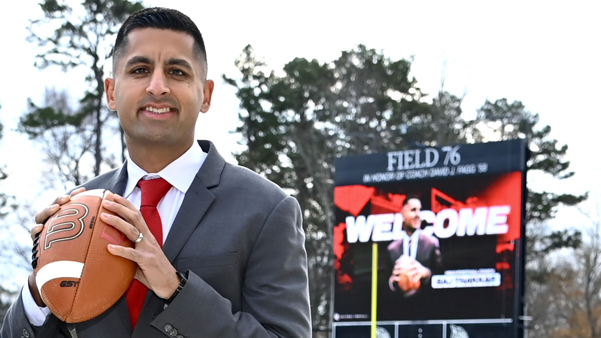 New Davidson football coach Saj Thakkar poses at the stadium before being introduced.