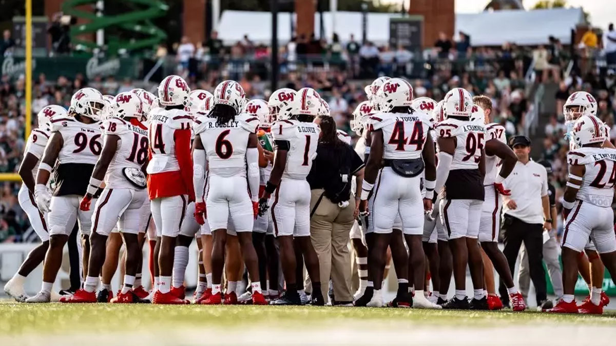 Gardner-Webb football players huddle during a 2024 game.