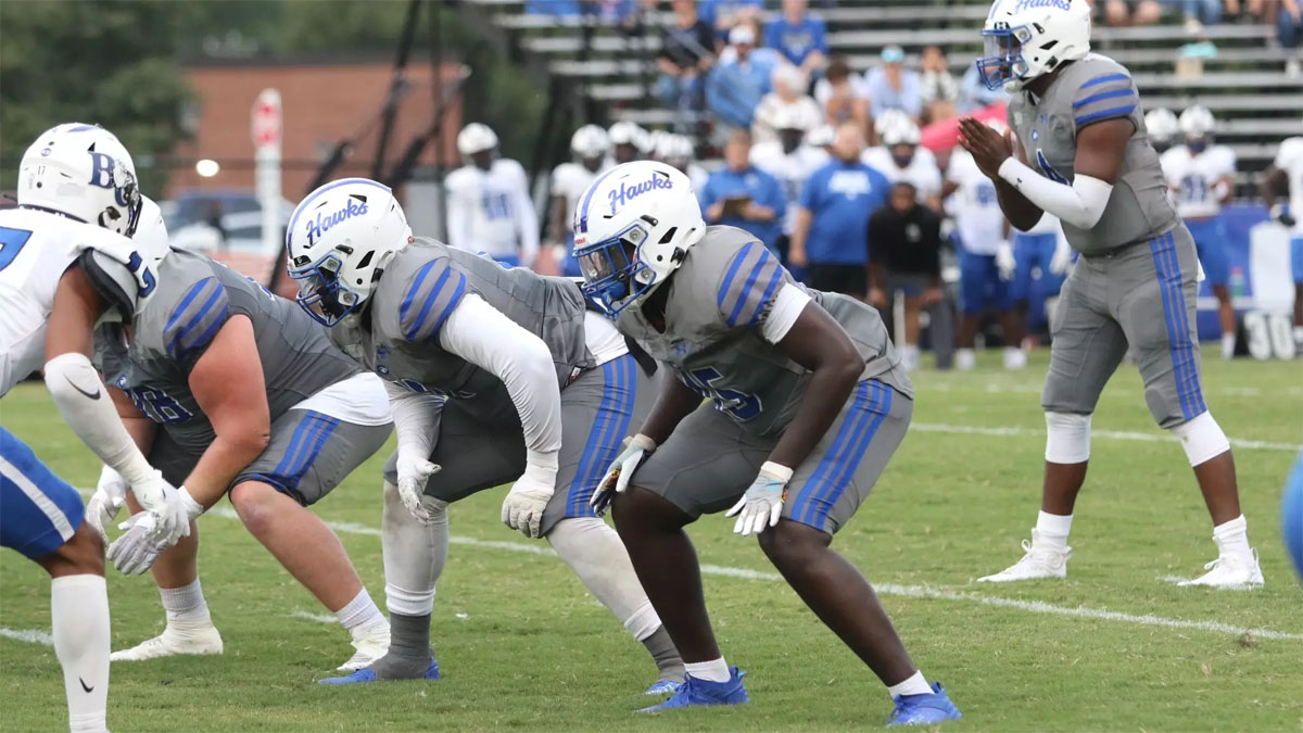 Chowan football players line up for a play against Barton in 2024