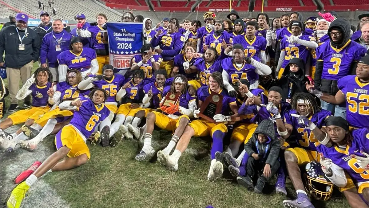 Tarboro football players pose after winning the 1A state championship in 2024.