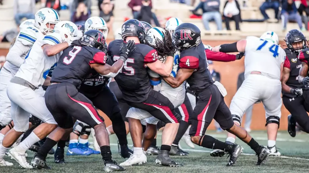 Lenoir-Rhyne players stack up West Florida in a 2019 Division II playoff game.