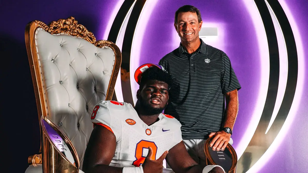 Clayton's Keshawn Stancil poses with Clemson head coach Dabo Swinney during his recent official visit.