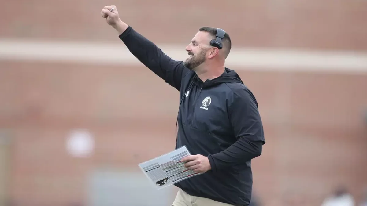 UNC Pembroke football coach reacts on the sidelines during a 2024 game.