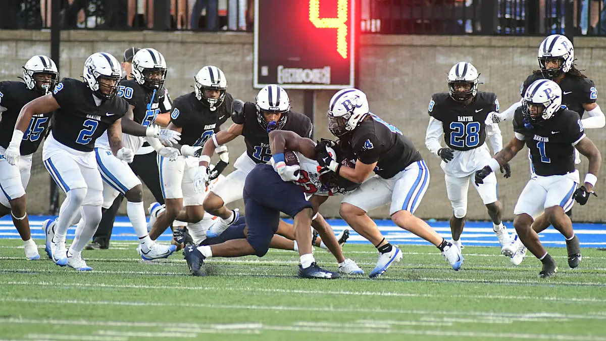 Barton football defenders surround a Virginia State ball-carrier