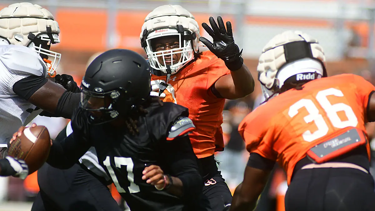 Campbell football defenders encircle quarterback Jalen Ferguson during an August preseason scrimmage