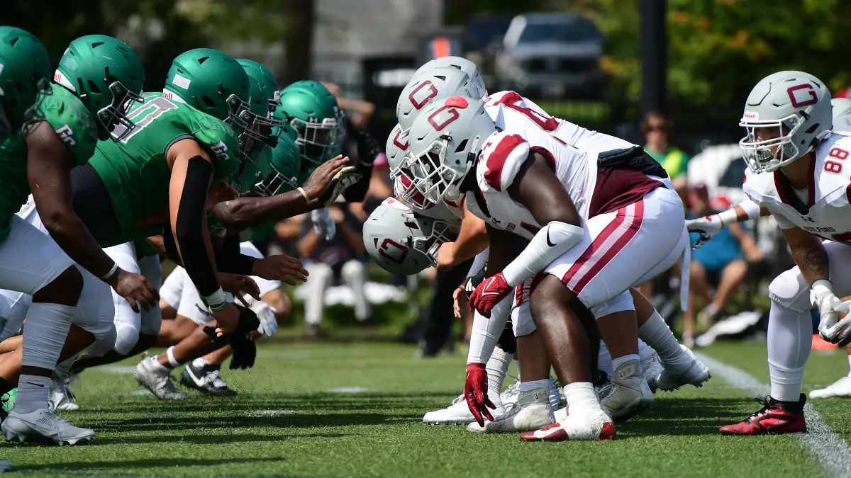 Greensboro and Guilford football players line up against each other during the 2024 Soup Bowl.