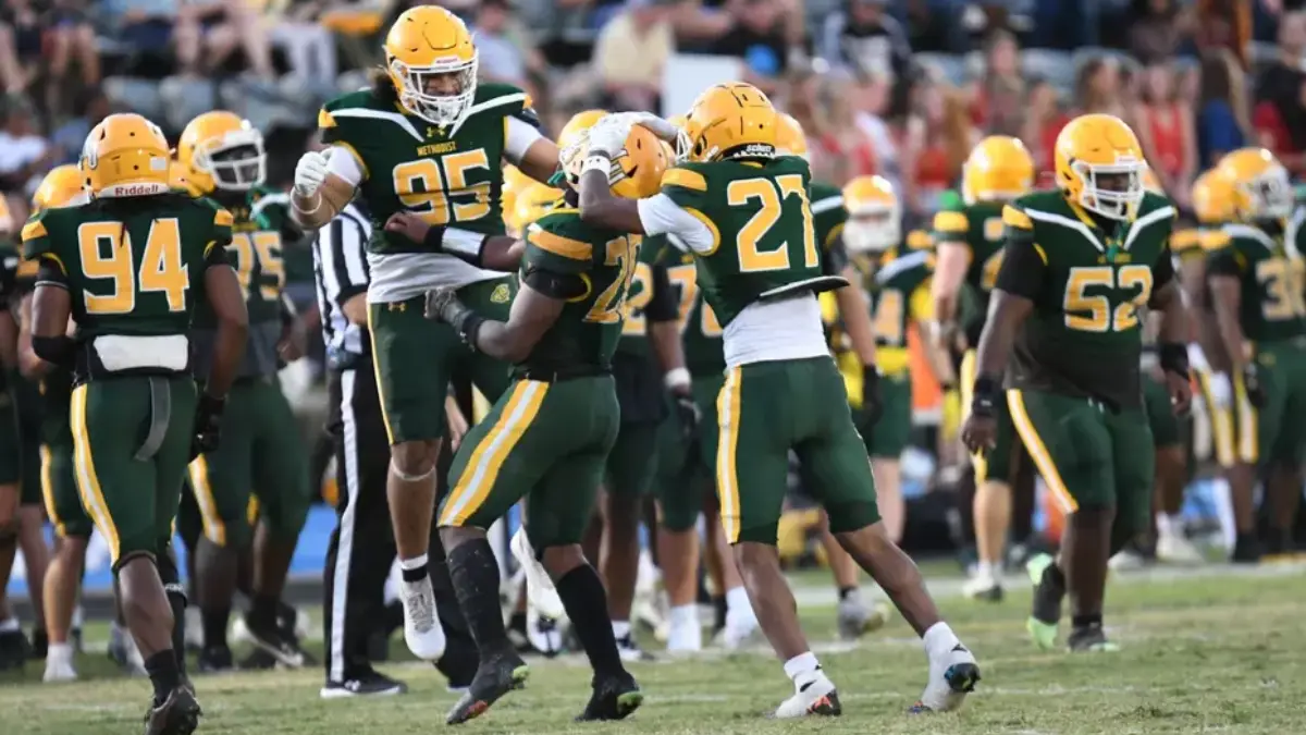 Methodist University football players celebrate after a big play against The Apprentice School.