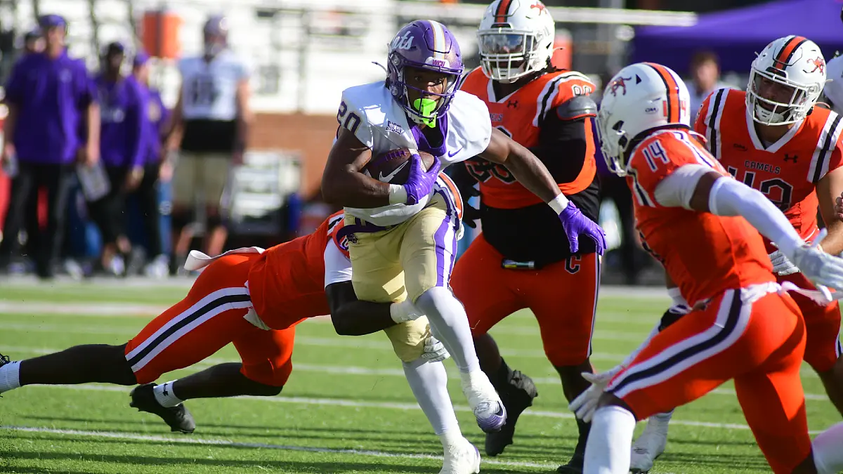 Western Carolina running back Camury Reid fights off a trio of Campbell tacklers.