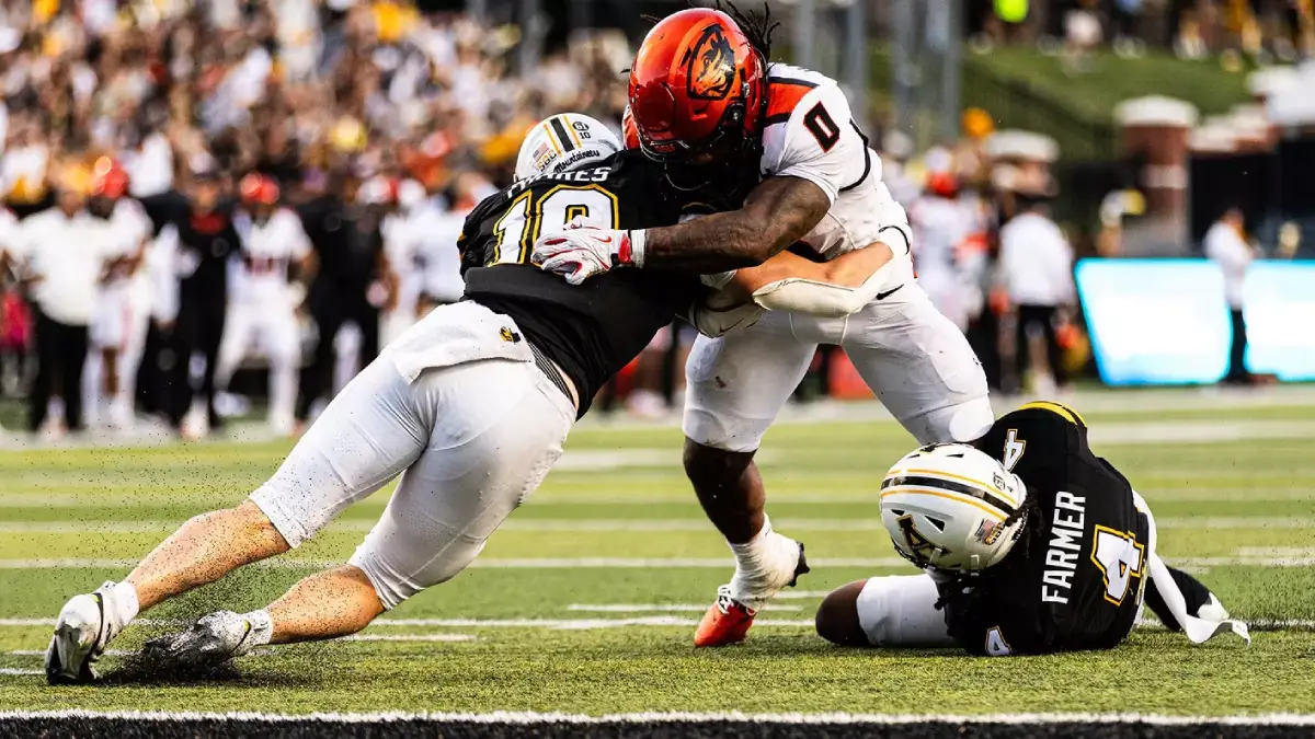 App State defenders Colton Phares and Myles Farmer stack up a fourth down Oregon State run near the goal line, a big play in the Mountaineers' win.