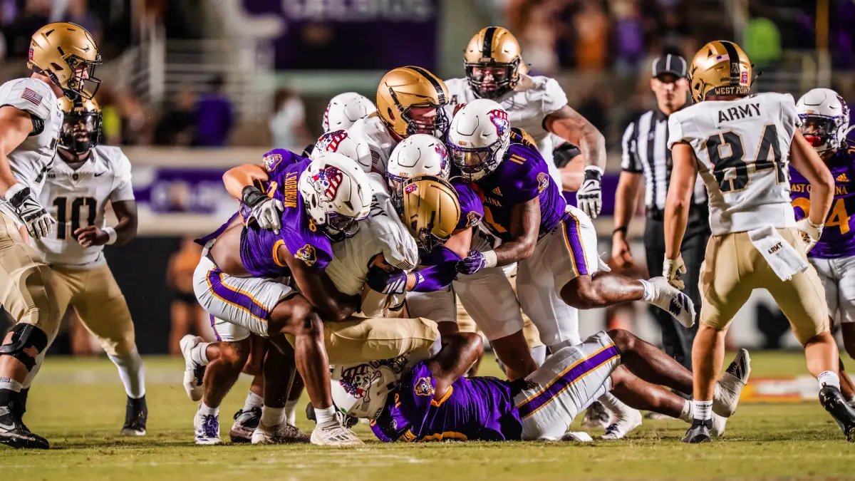 East Carolina defenders stack up Army in a 2025 American Conference football game