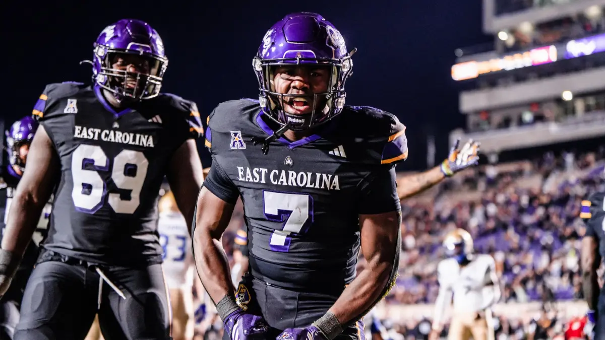 ECU football player Samuel Dankah (7) and Emmanuel Poku celebrate during the Pirates win over Tulsa.