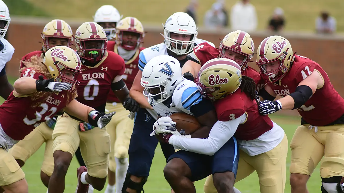 Elon football defenders surround a Villanova ball-carrier on a running play.