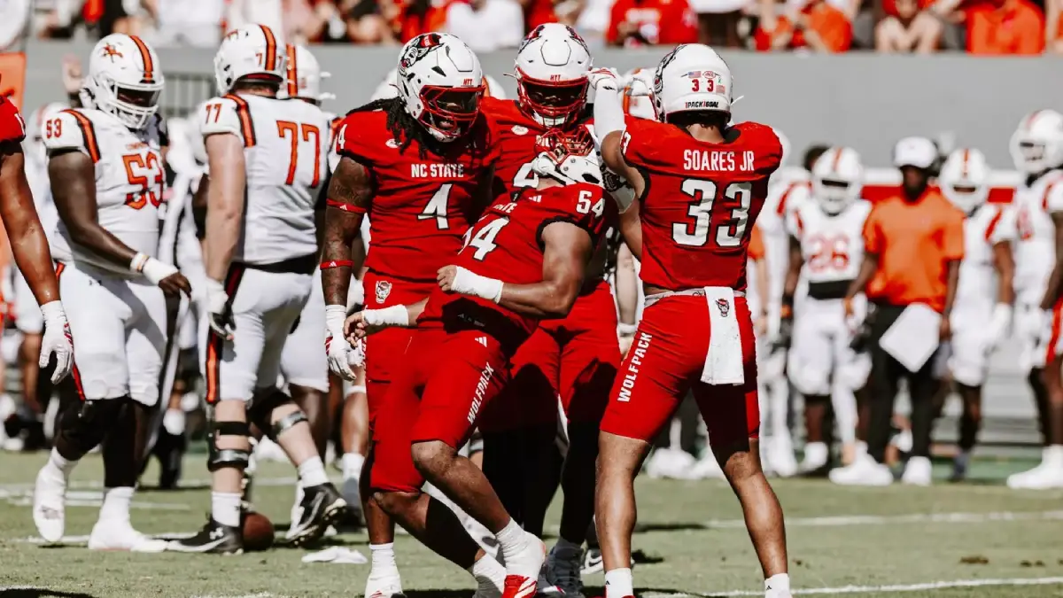 NC State football players celebrate a big play against Campbell.