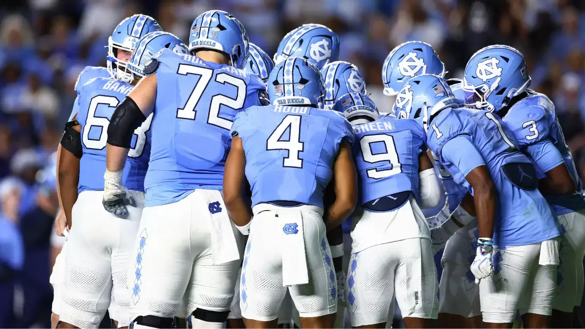 UNC Football vs. Clemson - NCFootballNews UNC football players huddle up during a 2025 football game against TCU. The Heels will play Clemson this weekend