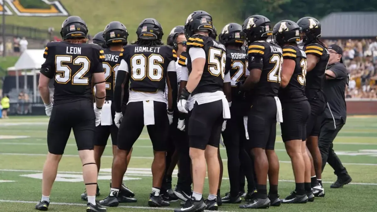 App State football players huddle up during a time out.