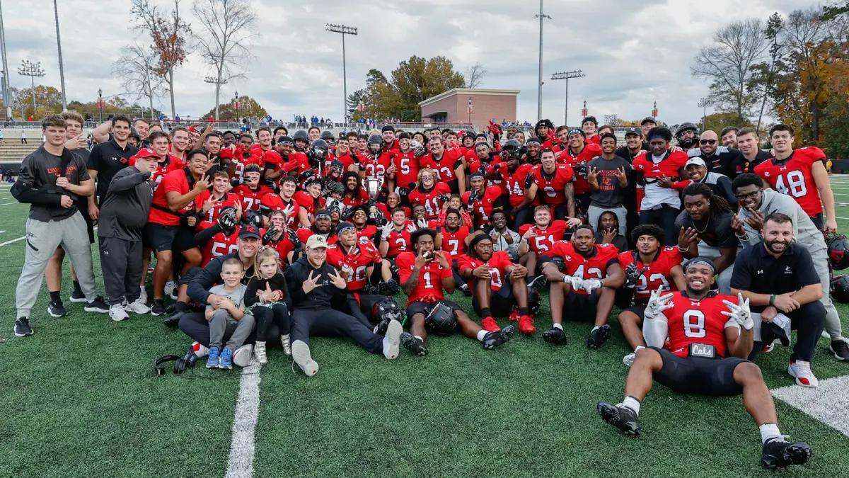 Davidson's football team poses for a group picture following its upset win over Presbyterian.