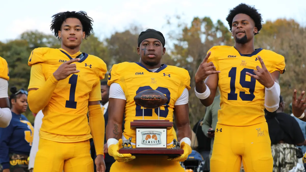 Johnson C. Smith football players hold the Commemorative Classic trophy after beating Livingstone.