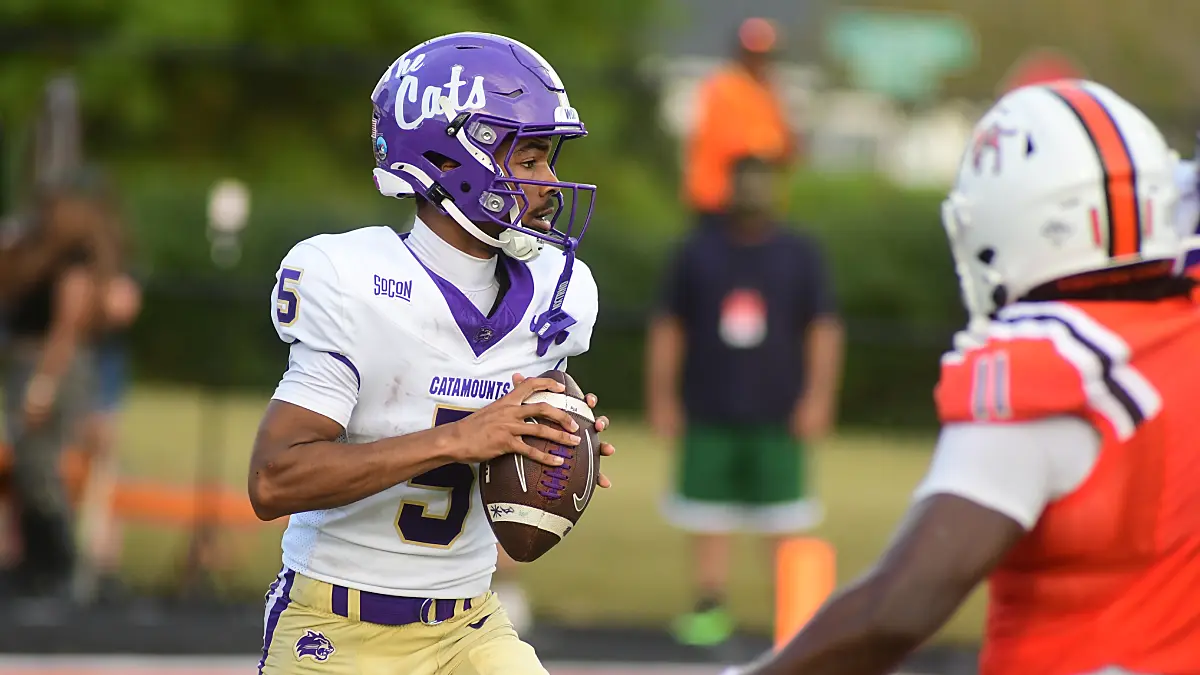 WCU quarterback Taron Dickens drops back to pass against Campbell