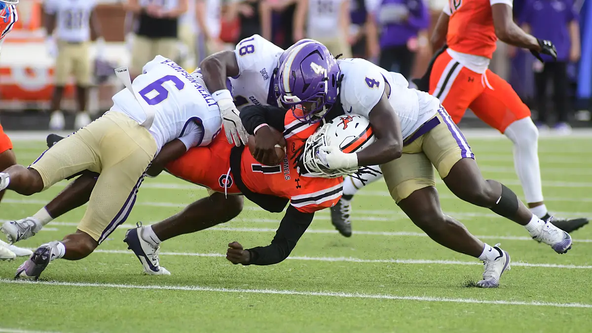Western Carolina defenders team-tackle a Campbell ball-carrier in September 2025.
