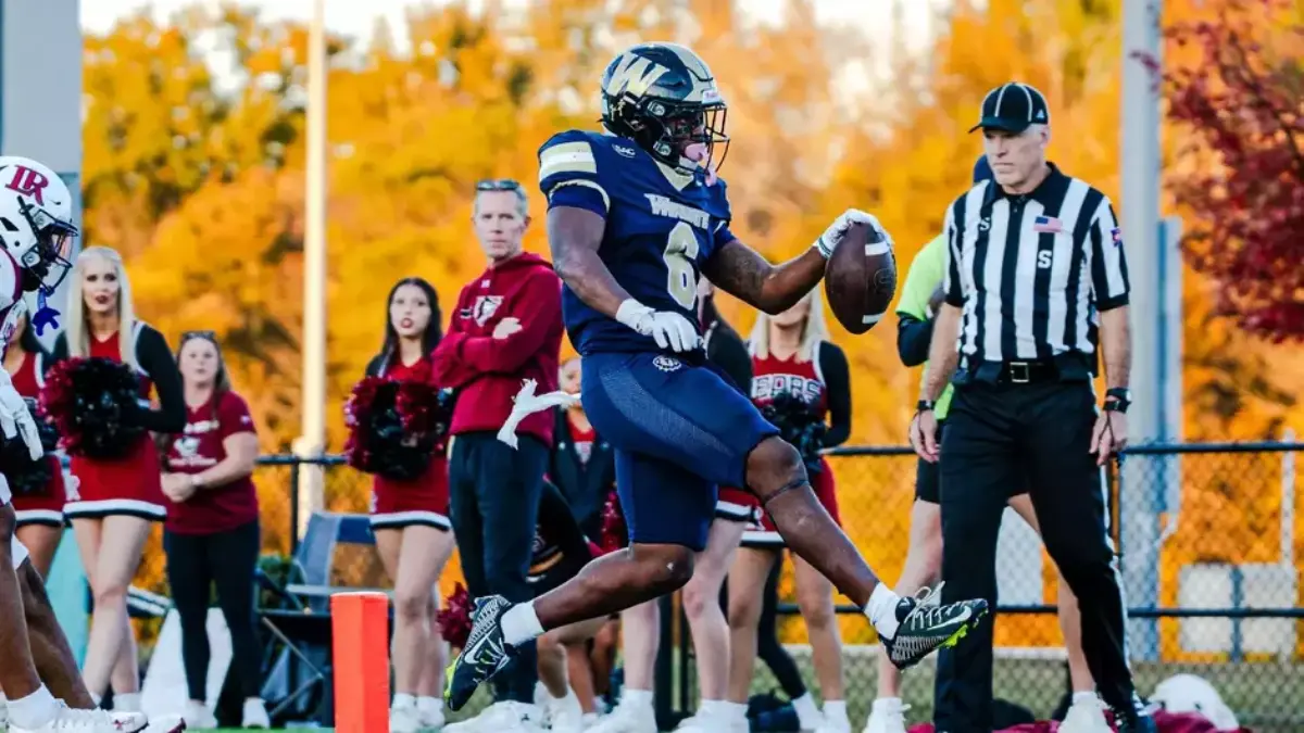 Wingate's Xavier Pugh struts into the end zone against Lenoir-Rhyne.