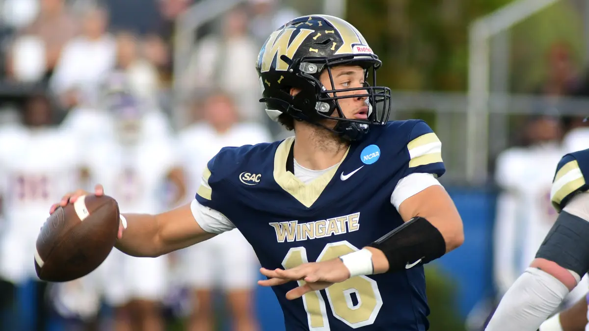 Wingate football quarterback Elijah Holmes rares back to throw in the Bulldogs' playoff game against Benedict.