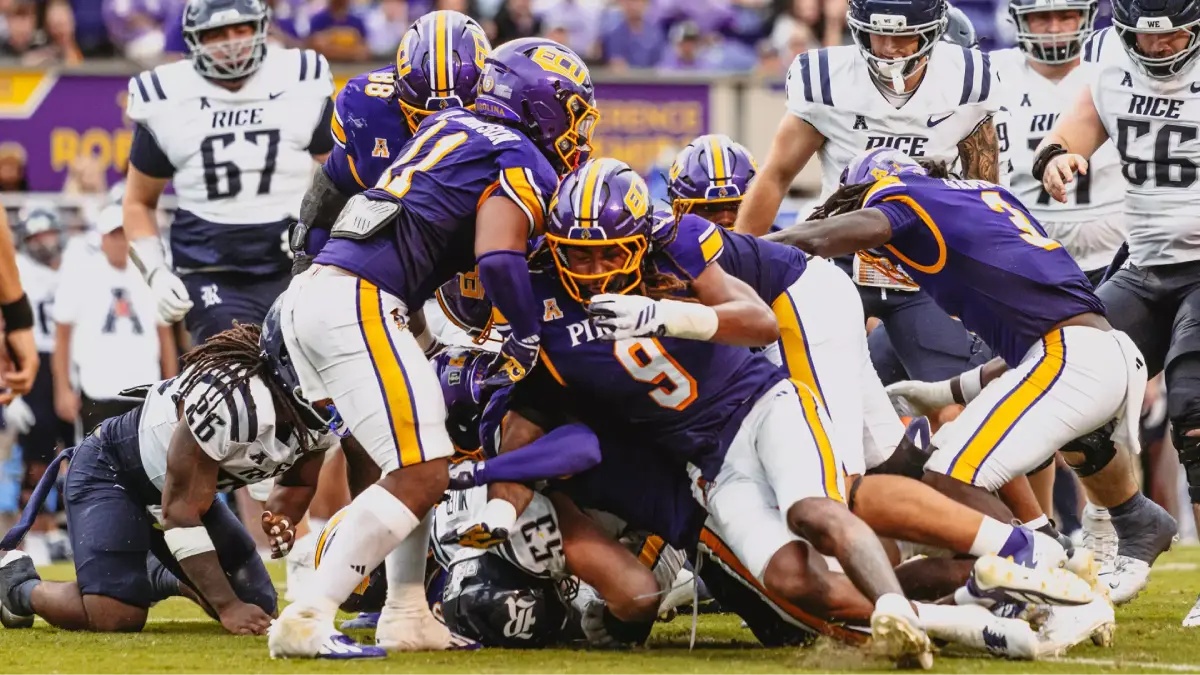 East Carolina football players stack up a play against Rice on Oct. 10 in Greenville, NC